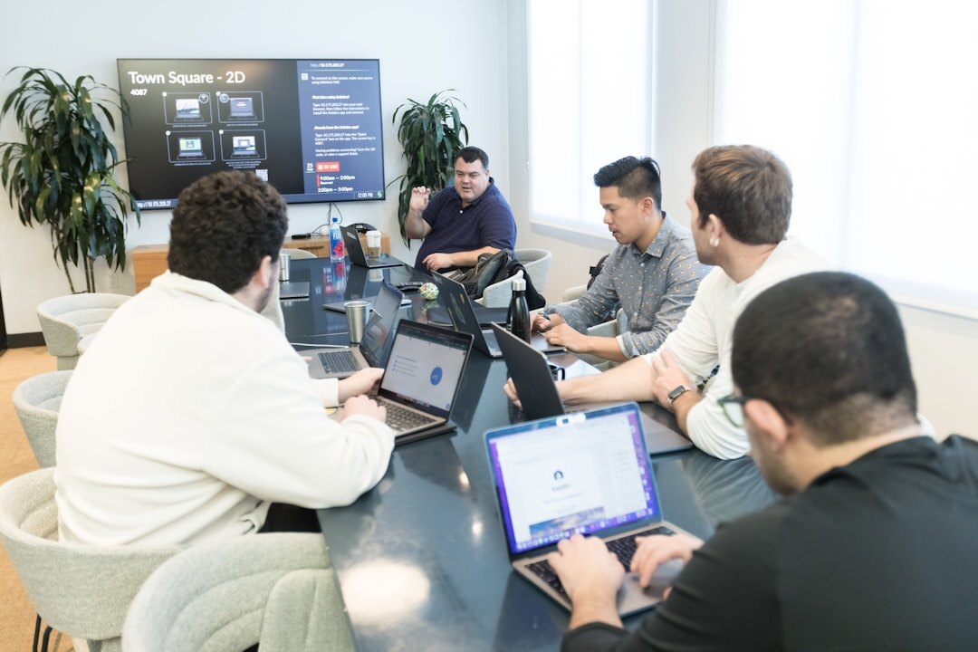 Modern tech startup office with team collaborating at computers